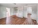 Living room featuring light wood floors, a whitewashed brick fireplace, and neutral walls at 6513 Old Post Rd, Charlotte, NC 28212