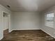 Bright living room with wood floors and natural light streaming through the window, creating an inviting space at 6513 Old Post Rd, Charlotte, NC 28212