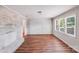 Bright living room with light wood floors, and a decorative whitewashed brick fireplace at 6513 Old Post Rd, Charlotte, NC 28212