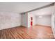 Bright living room with wood floors, neutral paint, and brick accent wall at 6513 Old Post Rd, Charlotte, NC 28212