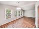 Bright living room with wood floors, chandelier, and large windows at 6513 Old Post Rd, Charlotte, NC 28212