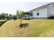 View of the backyard with manicured lawn, pond with fountain, and white siding house at 7337 Overjoyed Xing, Charlotte, NC 28215