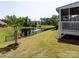 Backyard with a view of a serene pond, fountain, and a screened in back porch at 7337 Overjoyed Xing, Charlotte, NC 28215