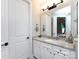 Well-lit bathroom featuring a granite vanity, a mirror, modern fixtures, and white cabinetry at 7337 Overjoyed Xing, Charlotte, NC 28215