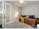 Neutral bedroom with a cozy bed, accent pillows, and a decorative glass paneled door at 7337 Overjoyed Xing, Charlotte, NC 28215