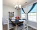 Cozy dining area with a modern chandelier, wooden table setting, and natural light from a nearby window at 7337 Overjoyed Xing, Charlotte, NC 28215