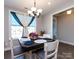 Bright dining room featuring a decorative table setting, chandelier, and a window with stylish curtains at 7337 Overjoyed Xing, Charlotte, NC 28215
