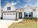 Charming single-story home with a two-car garage, stone accents, and a well-manicured front yard at 7337 Overjoyed Xing, Charlotte, NC 28215