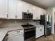 Modern kitchen featuring stainless steel appliances, granite countertops, and white cabinets at 7337 Overjoyed Xing, Charlotte, NC 28215