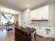 A kitchen with custom island, white cabinetry, and adjacent dining area, perfect for everyday meals and gatherings at 7337 Overjoyed Xing, Charlotte, NC 28215