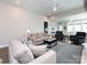 Spacious living room with a comfortable sofa, a coffee table, and hardwood floors, offering a relaxing atmosphere at 7337 Overjoyed Xing, Charlotte, NC 28215