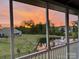 Orange sunset reflected in pond viewed from the screened in back porch at 7337 Overjoyed Xing, Charlotte, NC 28215
