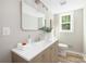 Bathroom vanity with large mirror, modern fixtures, and natural light from window at 7407 Limerick Dr, Charlotte, NC 28270
