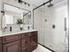 Modern bathroom boasts double vanity, black accents, and glass-enclosed shower at 7407 Limerick Dr, Charlotte, NC 28270