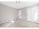 Bright bedroom with carpet flooring featuring closet and doors at 7407 Limerick Dr, Charlotte, NC 28270