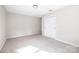Cozy bedroom includes a closet, neutral paint, carpeted floors, and modern lighting at 7407 Limerick Dr, Charlotte, NC 28270