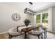 Elegant dining room with lots of sunlight, modern light fixture, and stylish decor at 7407 Limerick Dr, Charlotte, NC 28270