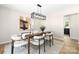 Dining room featuring a modern light fixture, wood table, and stylish decor at 7407 Limerick Dr, Charlotte, NC 28270
