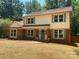 Charming two-story home featuring brick accents, new gutters, and green shutters surrounded by mature trees at 7407 Limerick Dr, Charlotte, NC 28270
