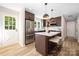 Modern kitchen featuring stainless steel appliances, an island with seating, and stylish pendant lighting at 7407 Limerick Dr, Charlotte, NC 28270