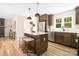 Modern kitchen with stainless steel appliances, kitchen island, and wood floors at 7407 Limerick Dr, Charlotte, NC 28270