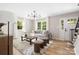 Bright living room features many windows, hardwood floors, stylish furniture, and modern lighting at 7407 Limerick Dr, Charlotte, NC 28270