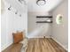 Mud room features bench, coat hooks, natural light from window, and floating shelves at 7407 Limerick Dr, Charlotte, NC 28270