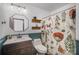 Charming bathroom with a vessel sink, decorative botanical shower curtain and an octagon mirror at 7434 Lawyers Station Dr, Mint Hill, NC 28227