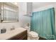 Bathroom featuring modern fixtures, a stylish mirror and a shower behind a curtain at 7434 Lawyers Station Dr, Mint Hill, NC 28227