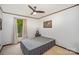 Clean bedroom with a ceiling fan, side table, and a large window offering outdoor views at 7434 Lawyers Station Dr, Mint Hill, NC 28227