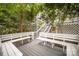 This house features a spacious backyard deck with built-in benches shaded by mature trees at 7434 Lawyers Station Dr, Mint Hill, NC 28227