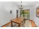Cozy dining area with wood table, chandelier, and sliding glass door to outdoor space with hardwood floors at 7434 Lawyers Station Dr, Mint Hill, NC 28227