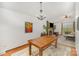 Cozy dining area with wood table, chandelier, and open view to living area with hardwood floors at 7434 Lawyers Station Dr, Mint Hill, NC 28227