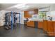 Home gym with state-of-the-art equipment, custom cabinets, and a rubber floor at 7434 Lawyers Station Dr, Mint Hill, NC 28227