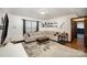 Cozy living room featuring a comfortable sectional sofa, stylish rug, and decorative shelving at 7434 Lawyers Station Dr, Mint Hill, NC 28227
