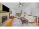 Inviting living room featuring a stone fireplace, hardwood floors, vaulted ceiling, and comfortable seating at 7434 Lawyers Station Dr, Mint Hill, NC 28227