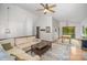 Open-concept living room with dining area, hardwood floors, and comfortable seating under a vaulted ceiling at 7434 Lawyers Station Dr, Mint Hill, NC 28227