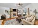 Inviting living room featuring a stone fireplace, hardwood floors, vaulted ceiling, and comfortable seating at 7434 Lawyers Station Dr, Mint Hill, NC 28227