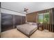 Main bedroom with a ceiling fan, built-in wardrobe closet and a window offering outdoor views at 7434 Lawyers Station Dr, Mint Hill, NC 28227