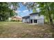 Large backyard with patio area and mature trees at 8208 Doverdale Ln, Charlotte, NC 28217
