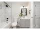 Stylish bathroom featuring a shower with marble tiling, a sleek vanity, and a modern design at 8208 Doverdale Ln, Charlotte, NC 28217
