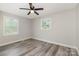 Bright and airy bedroom with two windows for natural light and a ceiling fan at 8208 Doverdale Ln, Charlotte, NC 28217