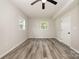 Bright bedroom with two windows providing natural light and a ceiling fan at 8208 Doverdale Ln, Charlotte, NC 28217