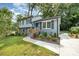 Updated exterior features a bright blue front door, newly landscaped flower beds, and a new concrete walkway at 8208 Doverdale Ln, Charlotte, NC 28217
