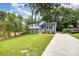 Beautifully landscaped front yard with a freshly poured concrete driveway leading to a charming two-story home at 8208 Doverdale Ln, Charlotte, NC 28217