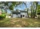 Back exterior view of the home and spacious backyard at 8208 Doverdale Ln, Charlotte, NC 28217