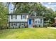 Charming two-story home featuring a blue front door, updated brick facade and a well-maintained lawn at 8208 Doverdale Ln, Charlotte, NC 28217