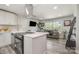 Modern open-concept kitchen with an island breakfast bar flows into a comfortable living area at 8208 Doverdale Ln, Charlotte, NC 28217