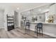 This open concept living room has hardwood floors and seamless access to dining room and staircase at 8208 Doverdale Ln, Charlotte, NC 28217