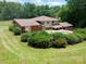Expansive backyard with a pool surrounded by lush greenery, offering a private outdoor retreat at 8417 Rolling Hills Ave, Hickory, NC 28602